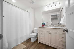 Full bath featuring vanity, recessed lighting, curtained shower, and dark wood finished floors