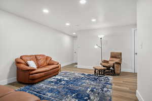 Living area featuring light wood-type flooring and recessed lighting