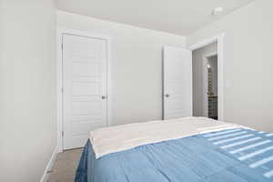 Carpeted bedroom with baseboards