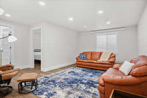 Living area featuring light wood-style floors and recessed lighting