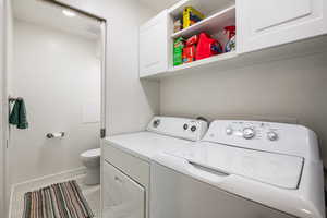 2052 Laundry room with cabinet space and washer and clothes dryer