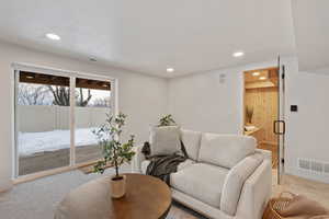 Carpeted living room with baseboards and recessed lighting