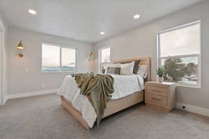 Bedroom with light carpet and recessed lighting