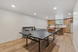 Game room with light wood finished floors and recessed lighting