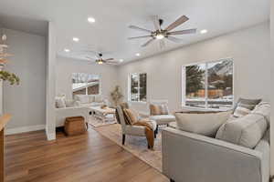 Living area with light wood-type flooring, recessed lighting, and ceiling fan