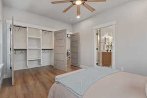 Primary bedroom with wood finished floors, ceiling fan, recessed lighting, and a closet