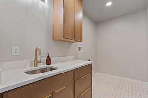 Laundry room featuring cabinet space, hookup for a washing machine, recessed lighting, and electric dryer hookup