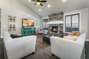 Living area with plenty of natural light, lofted ceiling, a fireplace, ceiling fan, and recessed lighting