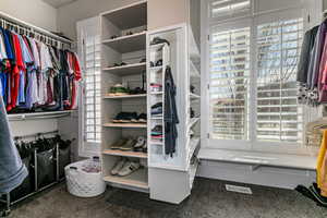 Walk in closet featuring dark carpet