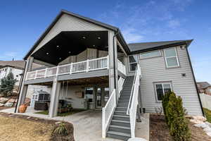 Back of property with a patio and a wooden deck