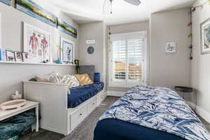 Carpeted bedroom featuring baseboards and a ceiling fan