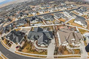 Aerial view of property and surrounding area featuring nearby suburban area