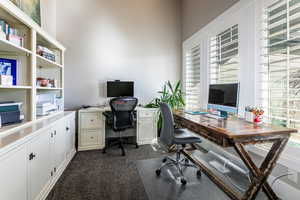 Office with dark colored carpet