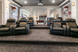 Home theater with recessed lighting and carpet