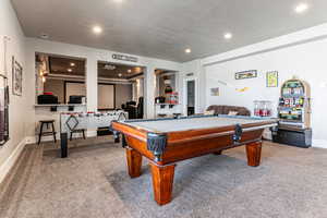 Recreation room with light carpet, billiards table, and recessed lighting