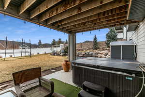 Fenced backyard with a patio and a hot tub