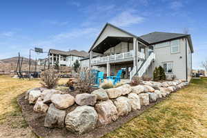 Rear view of property with a patio, a trampoline, and a yard