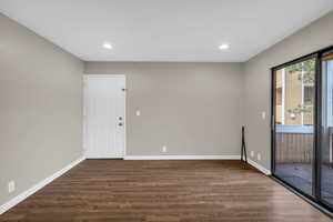 Unfurnished room featuring dark wood-style floors and recessed lighting