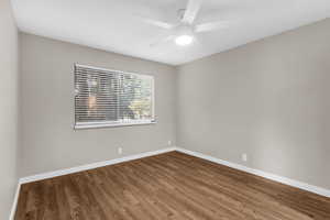 Empty room featuring wood finished floors and ceiling fan