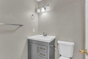 Bathroom featuring vanity and a textured wall
