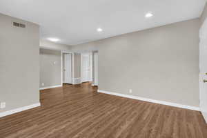 Empty room with wood finished floors and recessed lighting