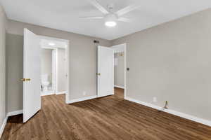 Unfurnished bedroom featuring wood finished floors and ceiling fan