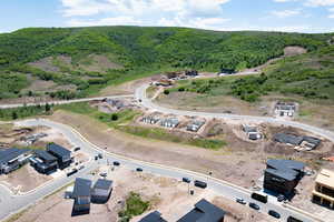 Aerial view of property's location with a heavily wooded area