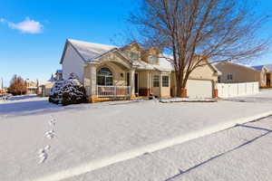 View of front of house featuring a porch and an attached garage