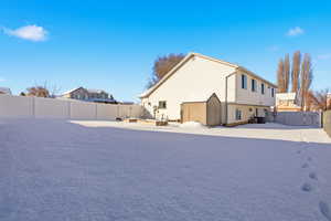 View of side of property featuring a gate and a fenced backyard