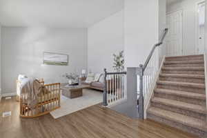 Stairs featuring wood finished floors and baseboards