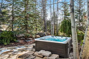 View of patio with a hot tub