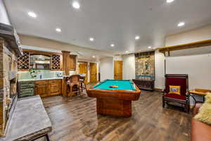 Game room featuring billiards table, recessed lighting, beverage cooler, wet bar, and dark wood-style flooring