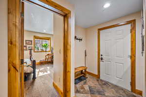 Entryway with recessed lighting and stone finish flooring