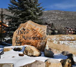 Community / neighborhood sign with a mountain view