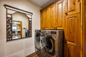 Laundry area with cabinet space and washing machine and clothes dryer