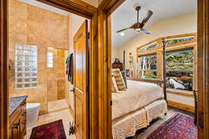 Bedroom with ceiling fan and vaulted ceiling