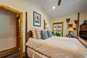 Bedroom featuring vaulted ceiling, dark wood finished floors, recessed lighting, and a ceiling fan