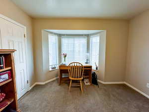 Dining space with carpet flooring and an office area