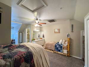 Carpeted bedroom featuring ceiling fan and connected bathroom