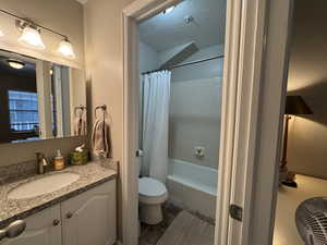 Full bathroom with vanity, a textured ceiling, and shower / bath combination with curtain