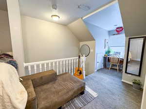 Sitting room featuring carpet and baseboards