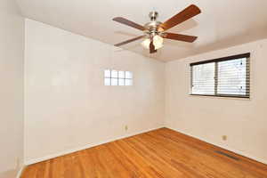Unfurnished room featuring wood finished floors and a ceiling fan