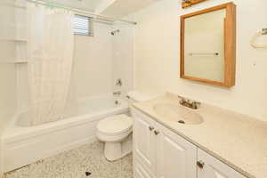 Full bath featuring shower / bath combination with curtain and vanity