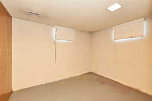 Finished below grade area featuring a textured ceiling