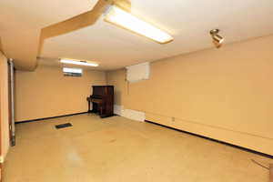 Below grade area featuring light floors