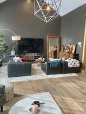 Living area featuring light wood-style flooring and lofted ceiling
