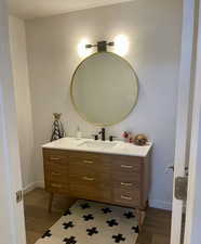 Bathroom featuring vanity and dark wood-style flooring
