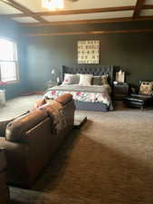 Bedroom featuring coffered ceiling and carpet