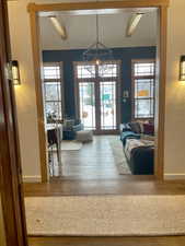 Interior space featuring a textured wall, light wood-type flooring, and french doors