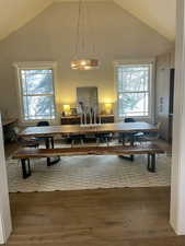 Dining room featuring a high ceiling and hardwood / wood-style floors